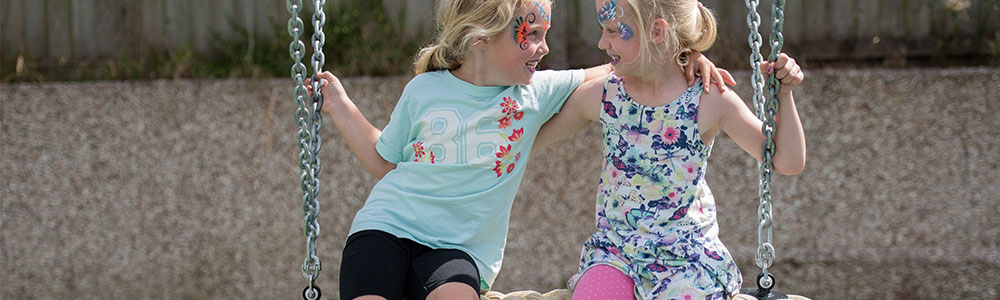 Twee meisjes spelen samen op een touwschommel